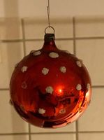 Antike, rote Weihnachtskugel mit weissen Punkten