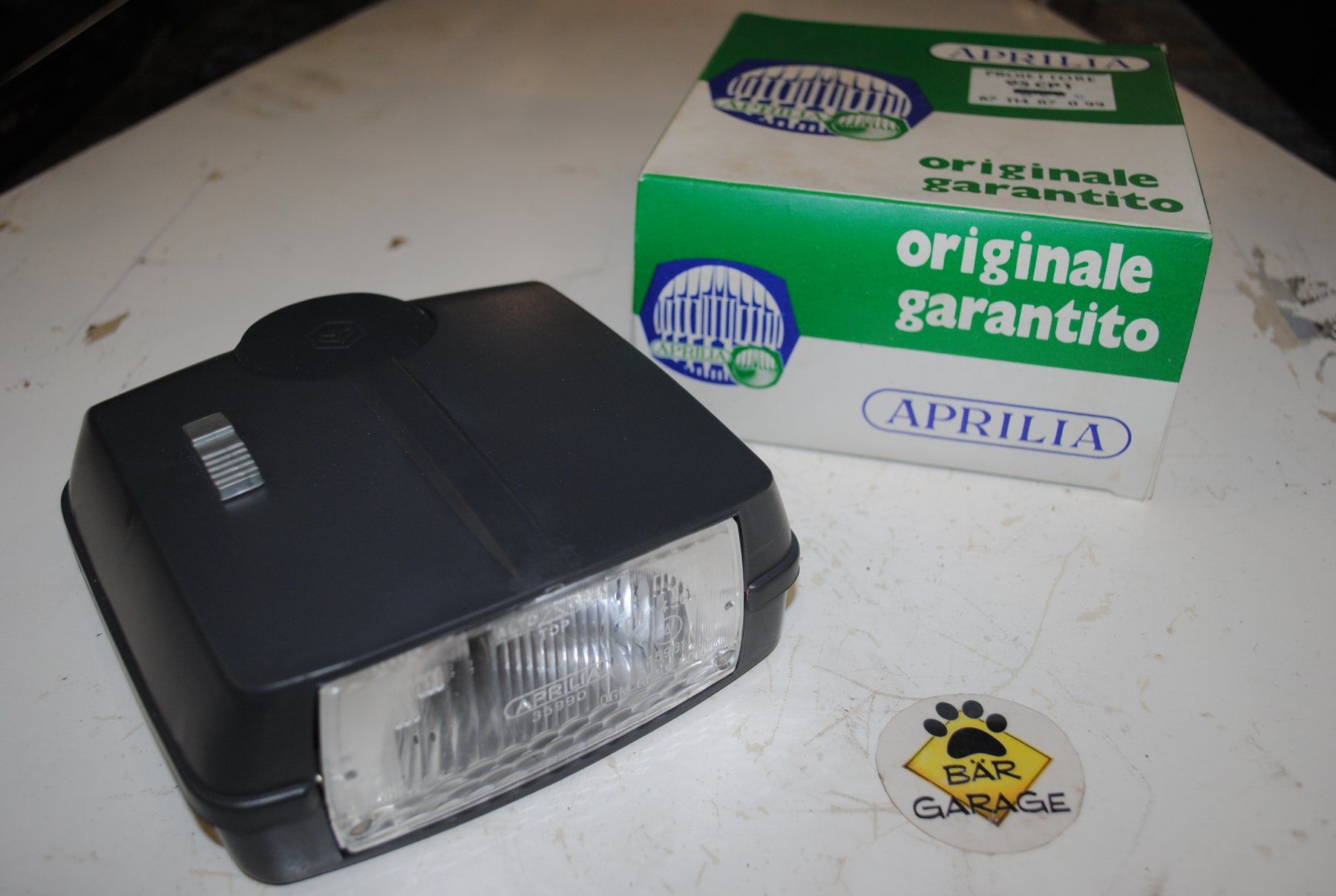 Piaggio Mofa-Ersatzteile: Lampe Scheinwerfer Piaggio Bravo  > NOS < original oldi – Neu und originalverpackt aus Subingen von Baergarage
