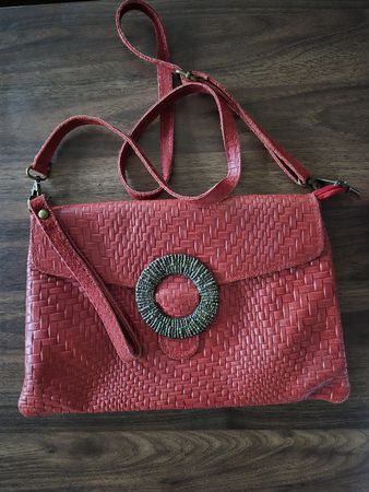 Red genuine leather evening bag with ring detail.