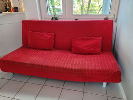 Red Sofa Bed with Pillows - Perfect for Summer Guests!