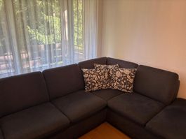 Ecksofa dunkelgrau Stoff mit Hocker guter Zustand