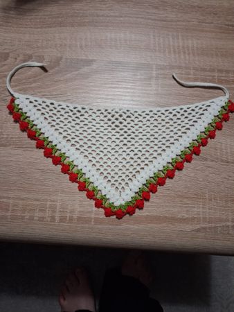 Gehäkeltes Dreieckstuch mit Rosenmuster als Kopfbedeckung.
