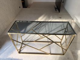 Goldener Konsolentisch mit dunkler Glasplatte