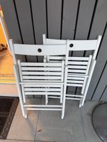 Two White Wooden Folding Chairs