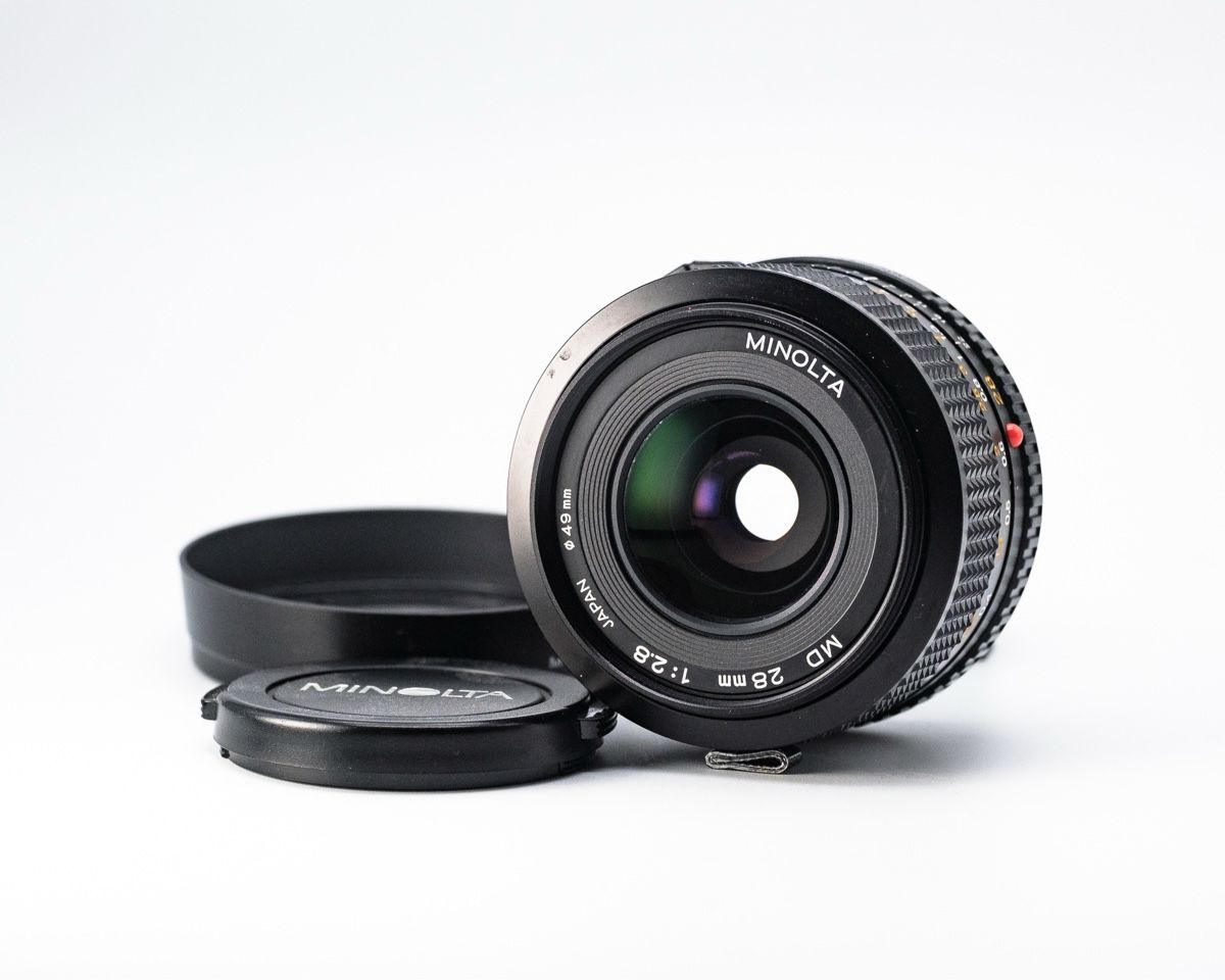 Minolta Objektive: Objectif MINOLTA MD 28mm 1:2.8 – Gebraucht aus Genève von Supablaz