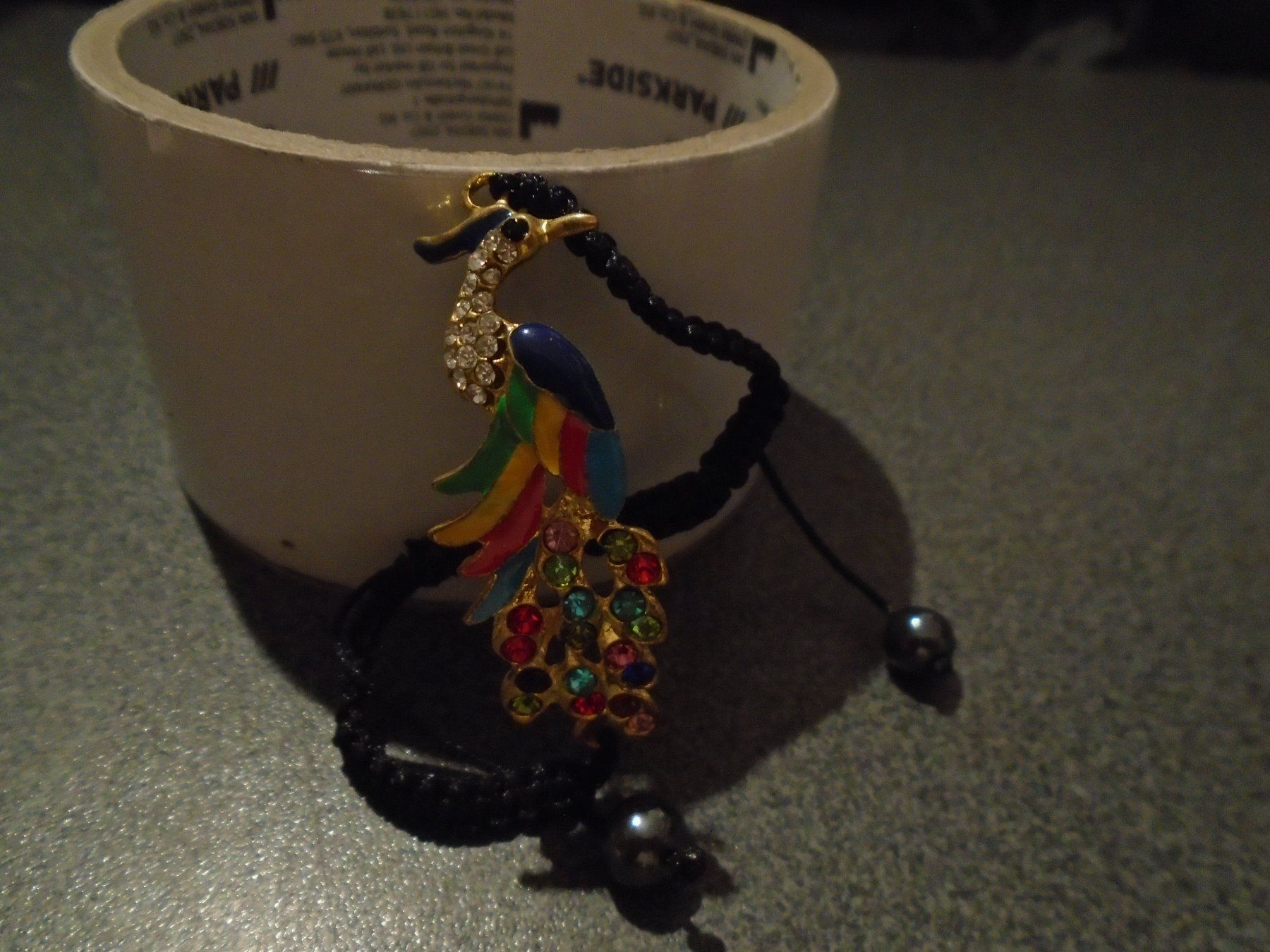 Bracciali & Braccialetti: Armband schwarz, Vogel farbig – Nuovo e nell'imballaggio originale da Zürich venduto da abraxas1291