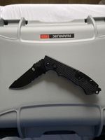 Couteau Gerber noir, lame partiellement dentelée, état neuf