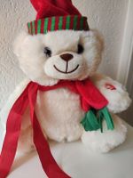 Weihnachtsbär mit roter Mütze und Schal, spielt Musik 