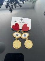 Herz-Ohrringe mit Auge und Münze, neu