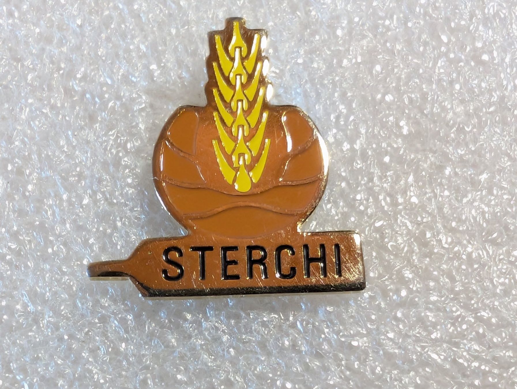 Placchette & Badge: Ansteckpin 287: Sterchi – Usato da Oppligen venduto da Pin-Fall-Shop