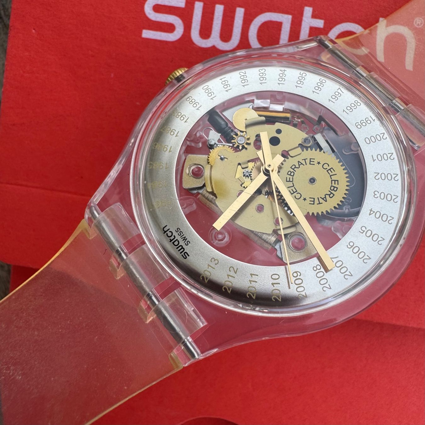 Swatch Montres: Swatch EST. 1983 SUOZ161 Skeleton Celebrate Transparent – D'occasion à Arzier-Le Muids par Avanna 1
