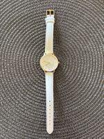 Montre femme cadran doré bracelet blanc bon état