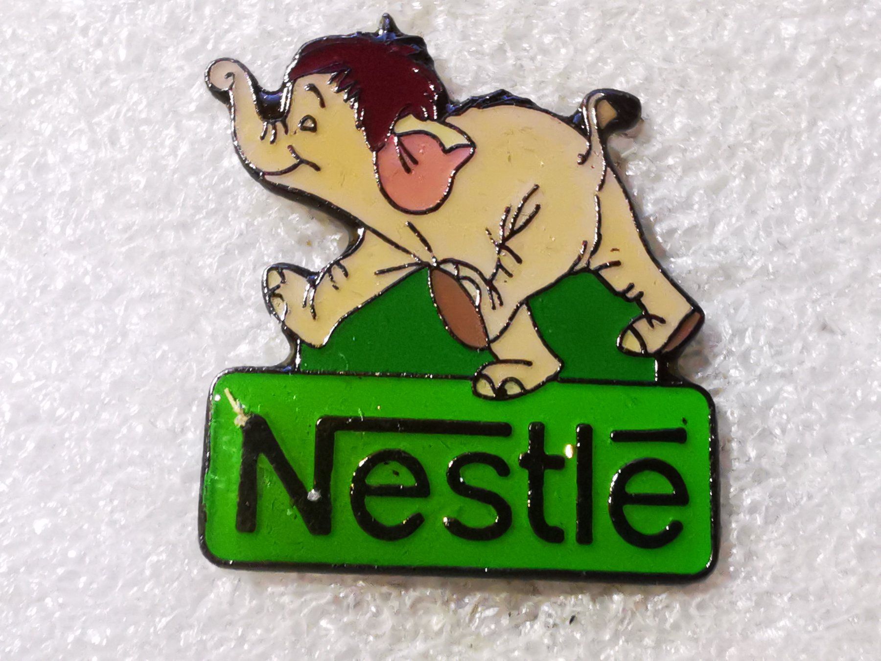 Placchette & Badge: Ansteckpin 98: Nestle – Usato da Oppligen venduto da Pin-Fall-Shop