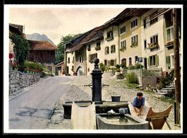 AK Greyerz /Freiburg, Straße mit Brunnen und Waschstelle