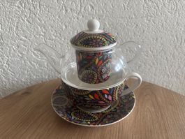 Teekanne mit Tasse und Teesieb