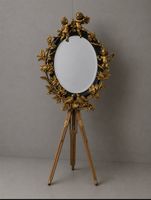 Specchio ovale dorato con putti su treppiede, stile antico