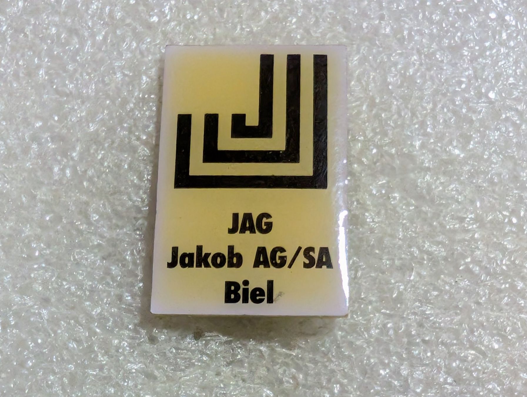 Placchette & Badge: Ansteckpin 196: Jakob AG Biel – Usato da Oppligen venduto da Pin-Fall-Shop