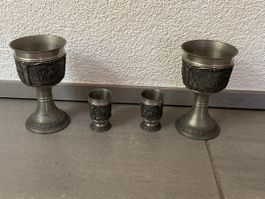Set of four pewter goblets with embossed scene motifs