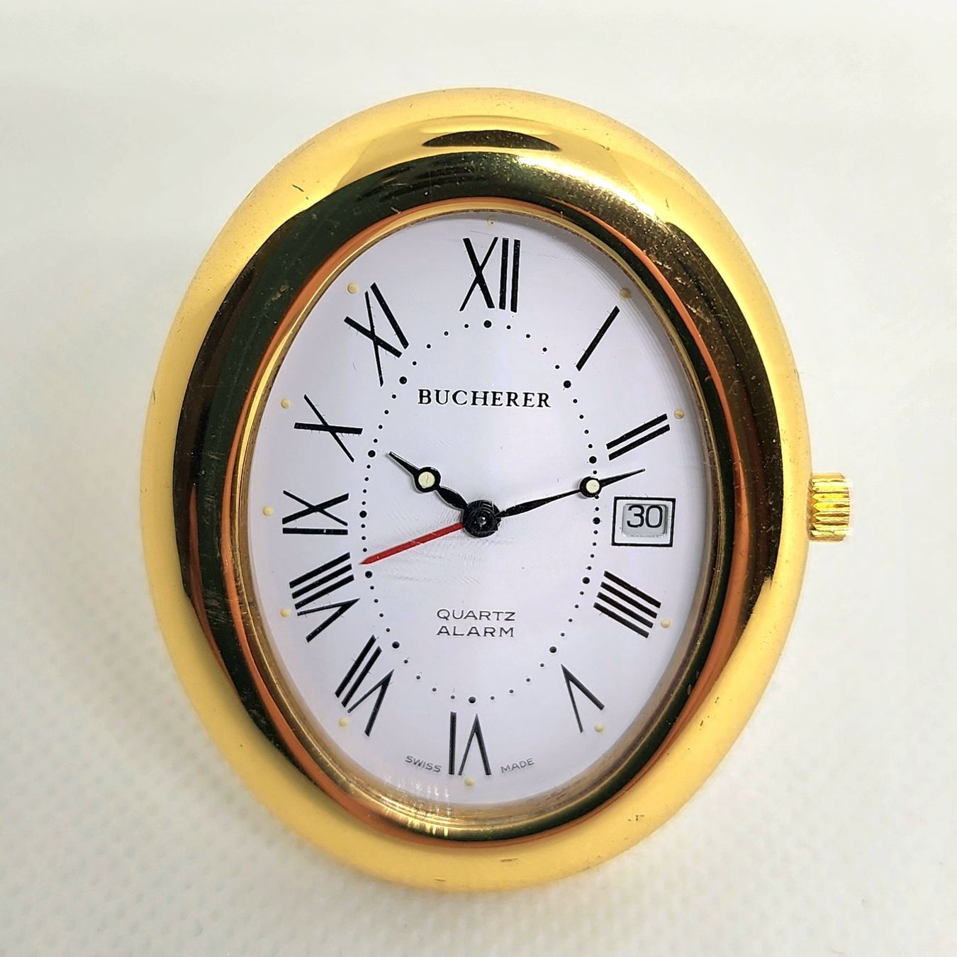 Bucherer Sveglie: Pendulette Bucherer quartz avec étui – Usato da Vevey venduto da var_5d8n