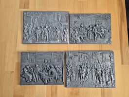 4 Gusseisenplatten mit Reliefdarstellungen