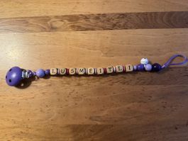 Nuggikette  Lusmeitli lila Holz guter Zustand