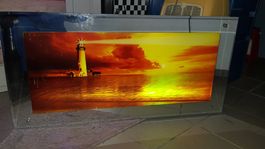 Bild Leuchtturm Meer    beleuchtet mit Spiegelrand SUNSET