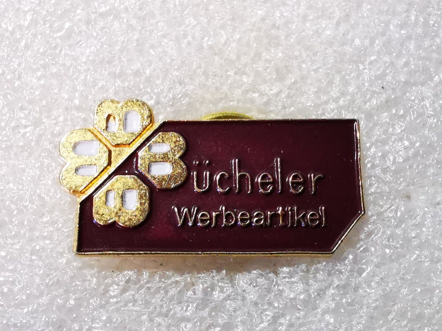 Placchette & Badge: Ansteckpin 38: Bücheler Werbeartikel – Usato da Oppligen venduto da Pin-Fall-Shop