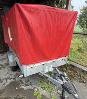 Anhänger mit roter Blache gebrauchter Zustand
