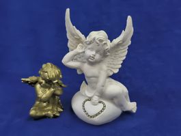 Zwei Engel Figuren weiss Keramik, Gold ist eine Wachskerze.