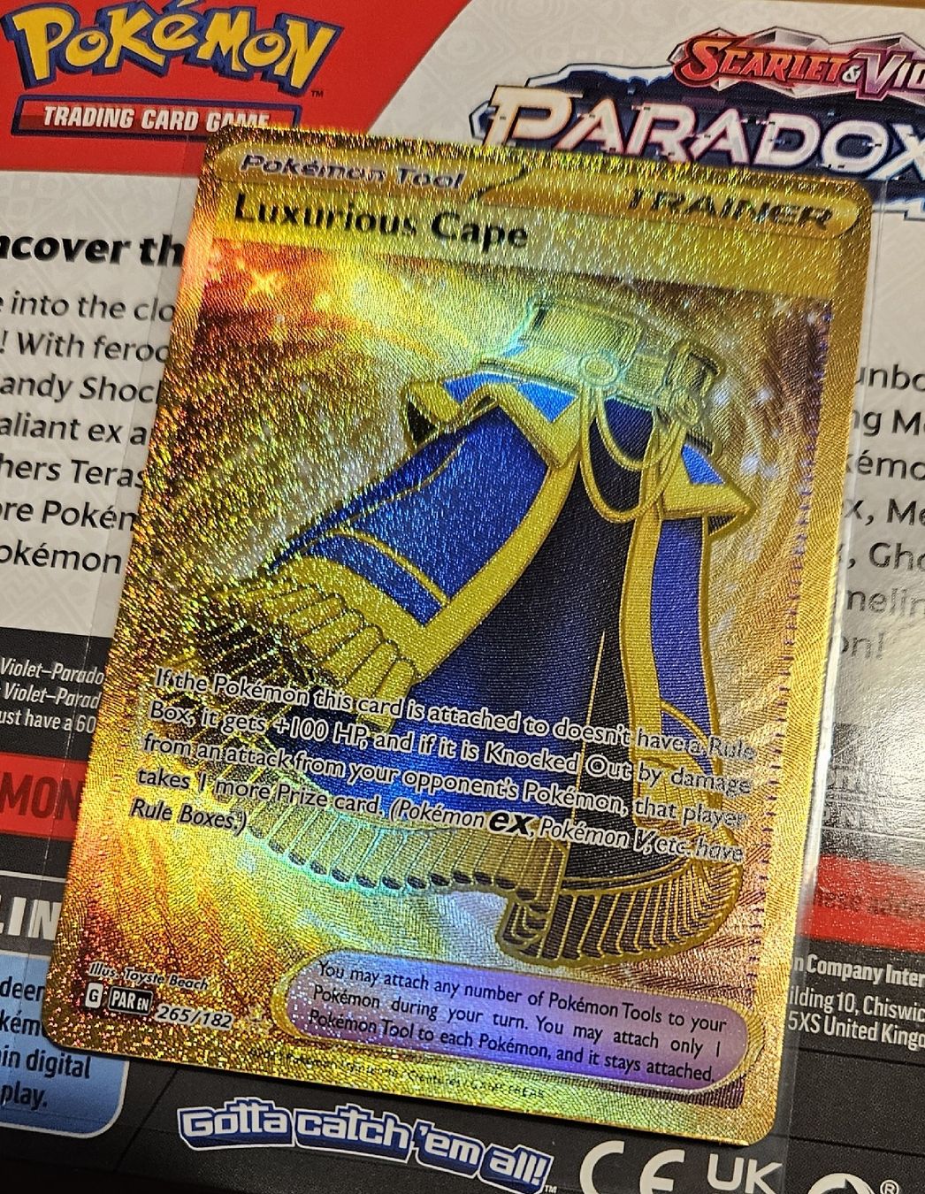 gold luxurious cape pokemon card - 265/182 - Paradox Rift - Hyper Rare - Foil If the Pokemon this card is attached to doesnt have a Rule Box Luxurious Cape 265/182 SV04: Paradox