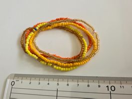 Handkette, farbige Chrälleli/Perlen, gelb/gold/orange