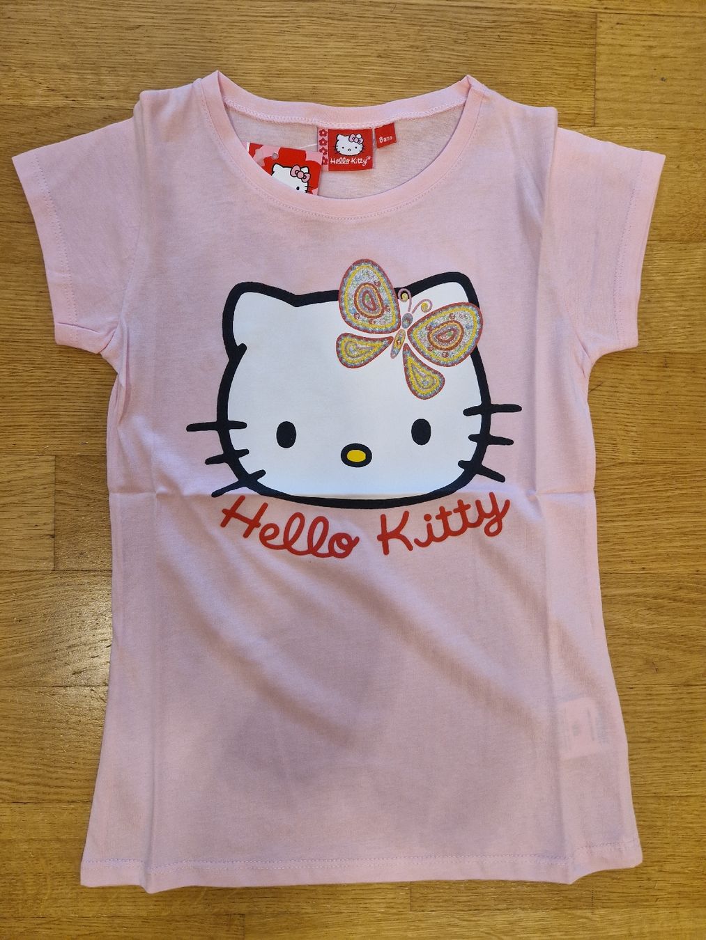 Camicette, T-shirt & Top: T-shirt Hello Kitty rose, neuf, taille 8 ans – Nuovo e nell'imballaggio originale da Penthaz venduto da Sosotroc 1