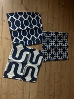 3 blue and white pillow cases