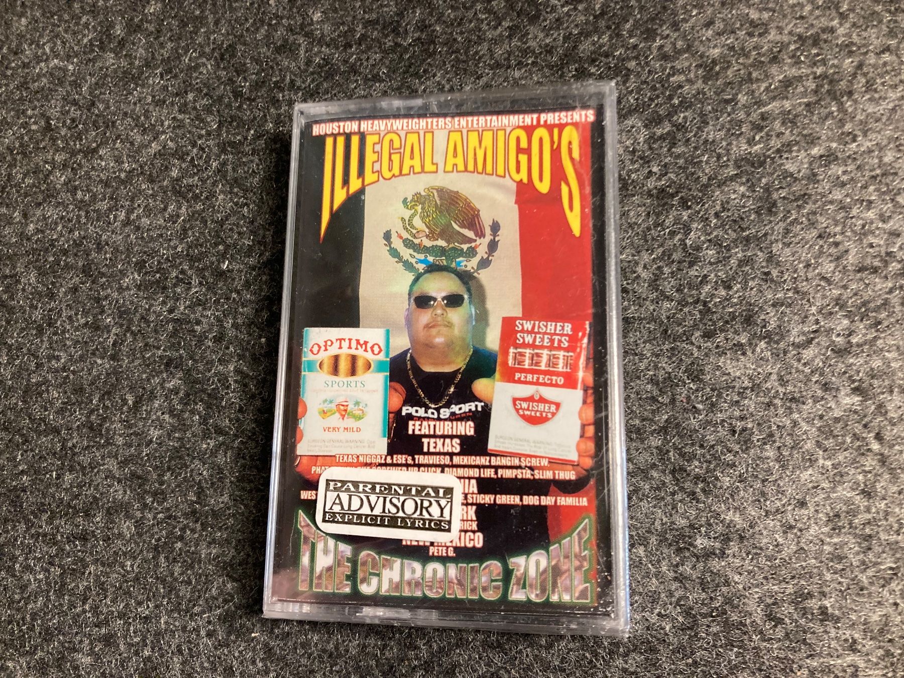 Musicassette: Illegal Amigo's - The Chronic Zone (MC) – Nuovo e nell'imballaggio originale da Fribourg venduto da Karushi