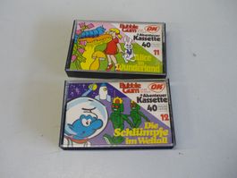 2 MC Kassetten - Die Schlümpfe im Weltall + Alice Wunderland