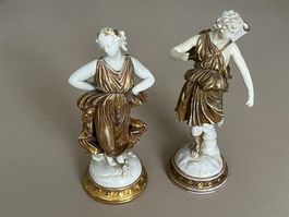 Coppia statuine in porcellana dorata