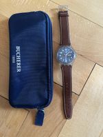 Swatch Uhr mit Lederarmband und Bucherer Tasche