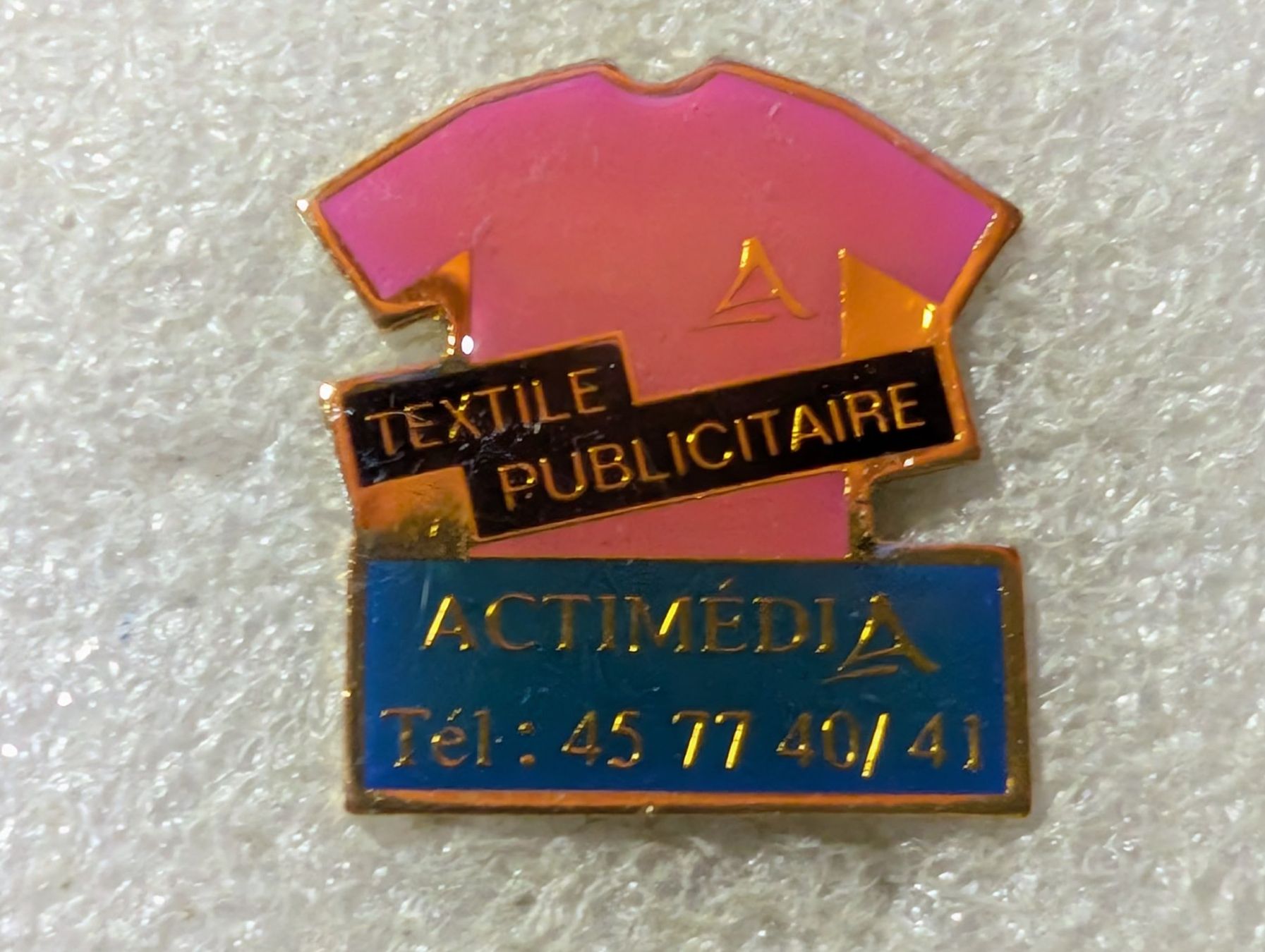 Placchette & Badge: Ansteckpin 128: Actimedia – Usato da Oppligen venduto da Pin-Fall-Shop