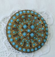 Antike Broche mit blauen Steinen, Goldfarben.