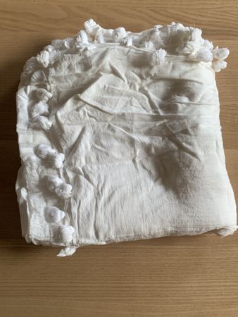 White scarf with pompom trim decorative