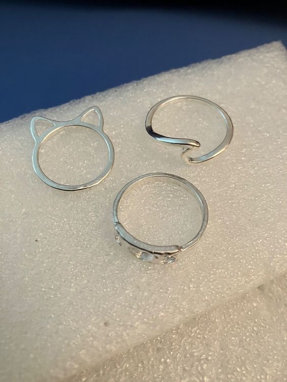 Silberfarbener Modeschmuck, 3 zarte Ringe, versch. Sujet (Neu (gemäss ...
