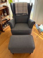 STRANDMON Ohrensessel, Nordvalla dunkelgrau mit Hocker