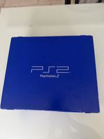 Boîte PlayStation 2 et deux jeux