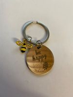 Porte-clés métal motif abeille inscription bee happy