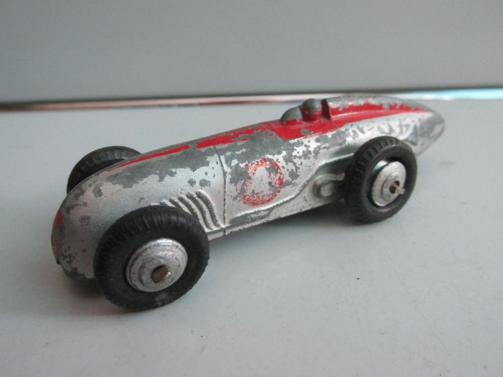 A small collection of Dinky Toys racing cars, comprising a No. 23J H.W