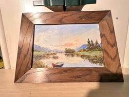 Peinture à l'huile encadrée, paysage lacustre et barque roug