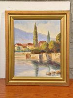 Landscape painting with village and water signed