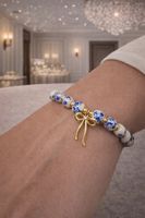 Bracciale perline stile porcellana con fiocco oro