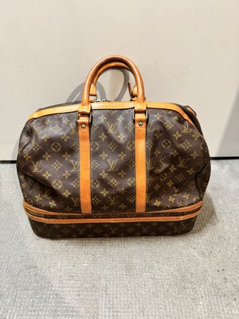 Sac de voyage Louis Vuitton cuir monogramme état usagé