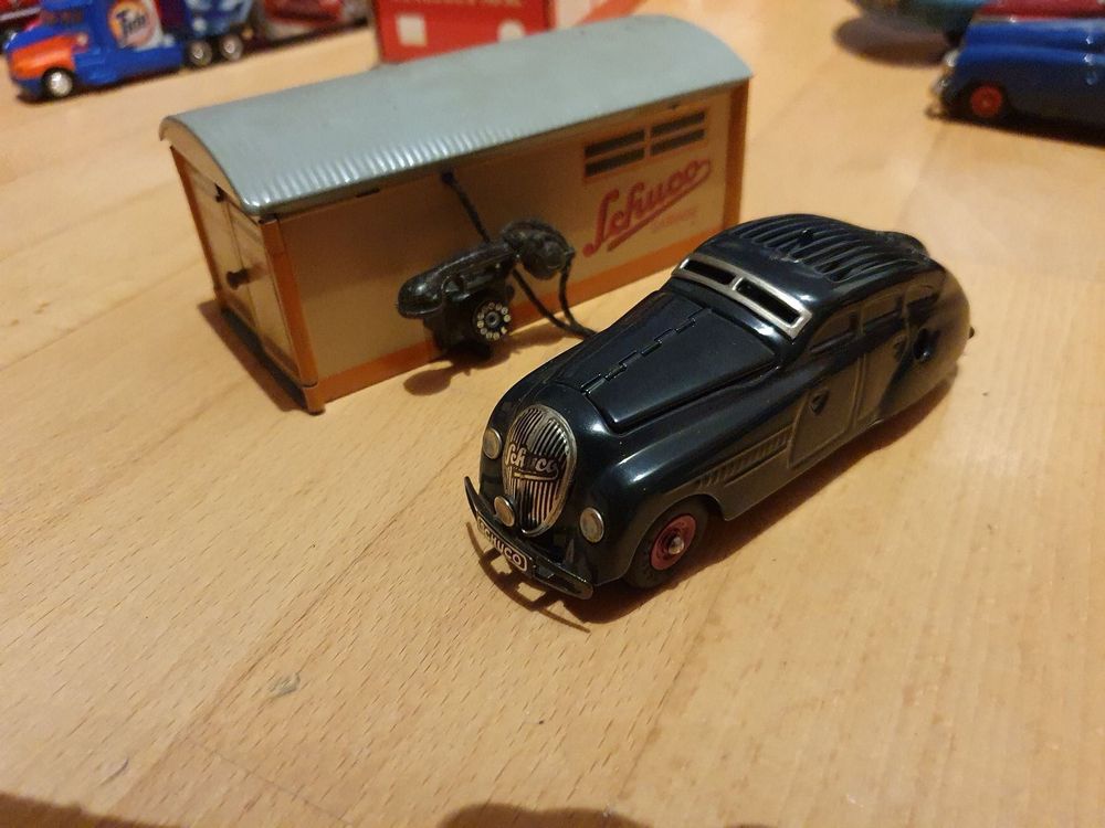 A tinplate Schuco 'Kommando Anno 2000' wind up car and a boxed Schuco garage
